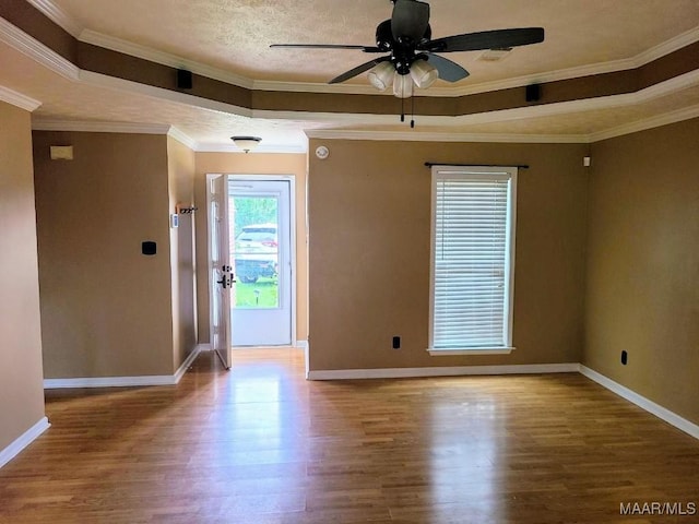 213 Foxdale Rd, Millbrook, AL 36054 - spare room featuring a tray ceiling, ceiling fan, wood finished floors, and ornamental molding