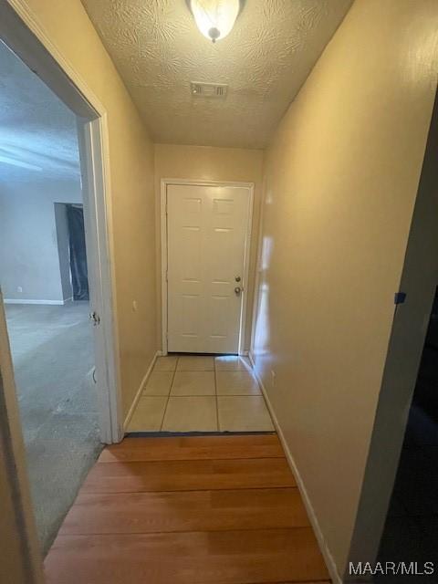 3440 Wickham Rd, Montgomery, AL 36116 - hallway featuring light wood-style flooring and a textured ceiling