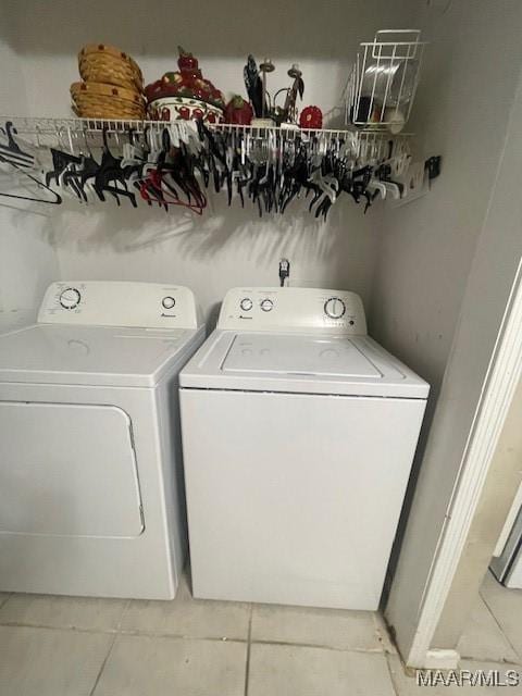 3440 Wickham Rd, Montgomery, AL 36116 - laundry room featuring washer and clothes dryer and light tile patterned flooring