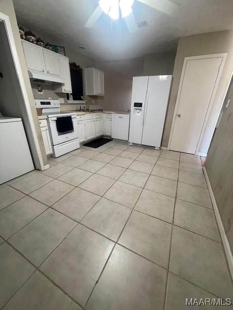 3440 Wickham Rd, Montgomery, AL 36116 - kitchen featuring white appliances, light tile patterned floors, under cabinet range hood, light countertops, and white cabinets
