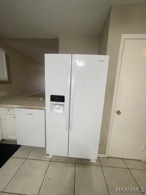 3440 Wickham Rd, Montgomery, AL 36116 - kitchen with white appliances, light tile patterned flooring, white cabinets, and light countertops