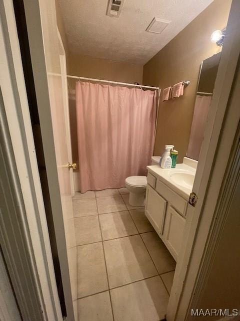 3440 Wickham Rd, Montgomery, AL 36116 - full bath featuring vanity, tile patterned floors, a textured ceiling, and a shower with curtain