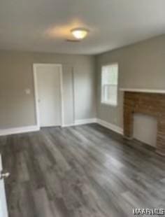 713 W Patton Ave, Montgomery, AL 36105 - unfurnished living room with baseboards and wood finished floors