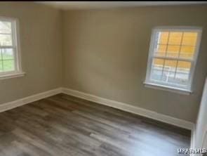 713 W Patton Ave, Montgomery, AL 36105 - unfurnished room with baseboards and dark wood finished floors