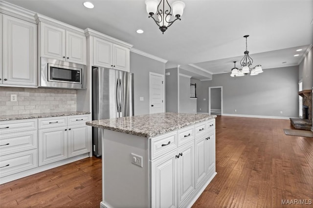 59 Gresham Dr, Millbrook, AL 36054 - kitchen featuring a chandelier, appliances with stainless steel finishes, open floor plan, ornamental molding, and recessed lighting
