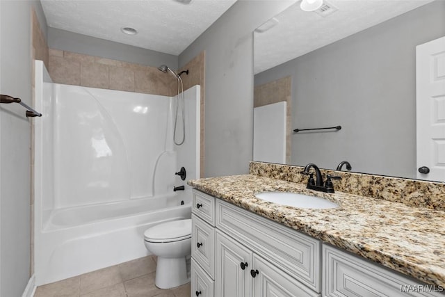 59 Gresham Dr, Millbrook, AL 36054 - full bathroom featuring vanity, washtub / shower combination, tile patterned flooring, and a textured ceiling