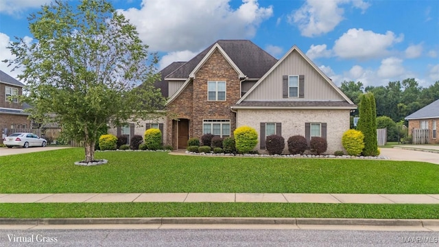 59 Gresham Dr, Millbrook, AL 36054 - craftsman inspired home with a front yard, brick siding, board and batten siding, and a shingled roof