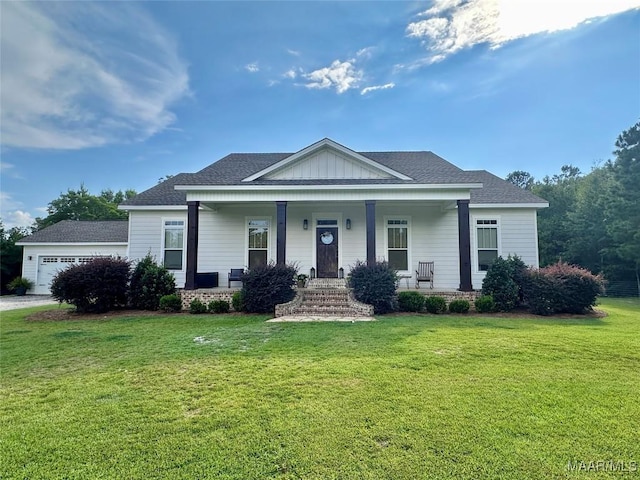 447 Cloverdale Rd, Greenville, AL 36037 - view of front facade featuring covered porch, a front lawn, an attached garage, and roof with shingles