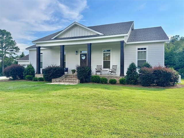 447 Cloverdale Rd, Greenville, AL 36037 - view of front of property with covered porch, a front lawn, roof with shingles, and board and batten siding