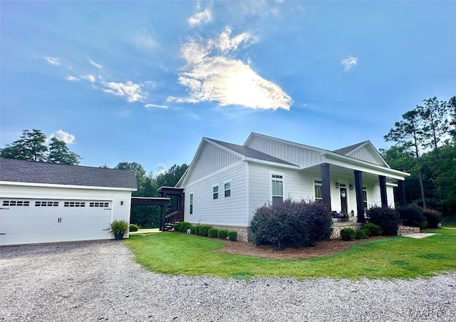 447 Cloverdale Rd, Greenville, AL 36037 - view of property exterior with covered porch, board and batten siding, a lawn, and a detached garage