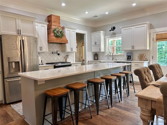 447 Cloverdale Rd, Greenville, AL 36037 - kitchen featuring appliances with stainless steel finishes, custom range hood, dark wood-type flooring, ornamental molding, and tasteful backsplash