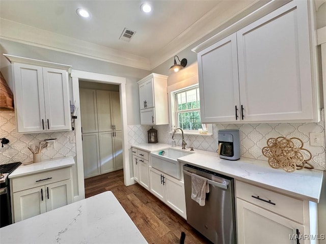 447 Cloverdale Rd, Greenville, AL 36037 - kitchen with stainless steel dishwasher, dark wood finished floors, recessed lighting, gas range, and ornamental molding
