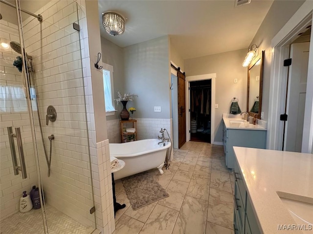 447 Cloverdale Rd, Greenville, AL 36037 - full bathroom with a shower stall, vanity, a soaking tub, marble look tile flooring, and tile walls
