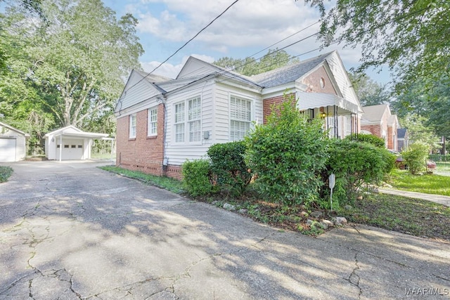 533 Morningview Dr, Montgomery, AL 36109 - view of property exterior with an outdoor structure, a detached garage, brick siding, and driveway