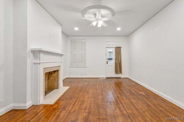 533 Morningview Dr, Montgomery, AL 36109 - unfurnished living room with a ceiling fan, wood finished floors, a tiled fireplace, and recessed lighting