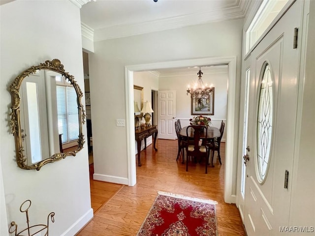 9865 Wynchase Cir, Montgomery, AL 36117 - entrance foyer featuring crown molding, a chandelier, and light wood-style flooring
