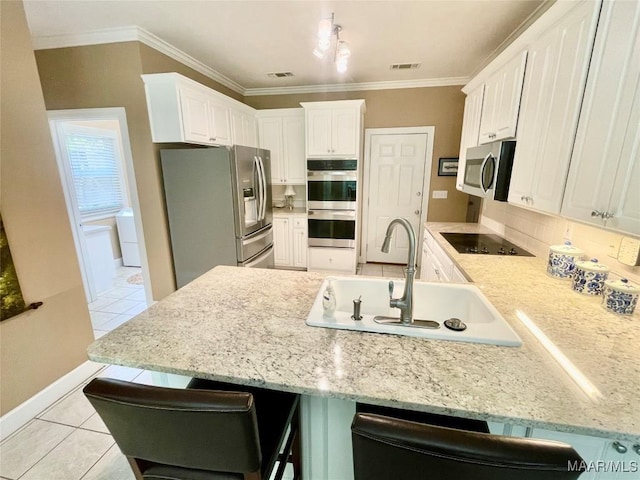 9865 Wynchase Cir, Montgomery, AL 36117 - kitchen featuring stainless steel appliances, a peninsula, light tile patterned floors, a breakfast bar area, and ornamental molding
