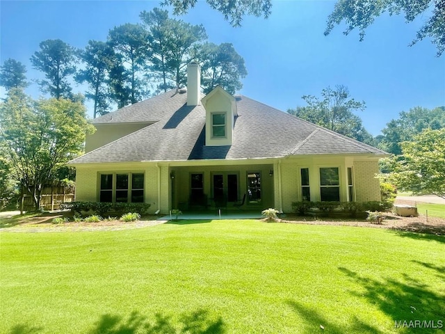 9865 Wynchase Cir, Montgomery, AL 36117 - rear view of house featuring brick siding, a lawn, roof with shingles, and a chimney