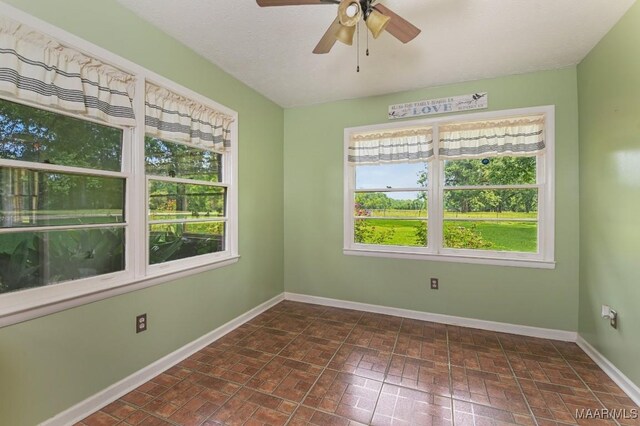 445 W Hickory Grove Rd, Lapine, AL 36046 - spare room featuring plenty of natural light, ceiling fan, and brick patterned floors