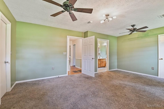 445 W Hickory Grove Rd, Lapine, AL 36046 - unfurnished bedroom with carpet flooring, a textured ceiling, a ceiling fan, and ensuite bath