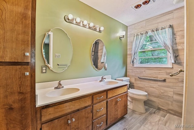 445 W Hickory Grove Rd, Lapine, AL 36046 - full bathroom with double vanity, a textured ceiling, and tile walls
