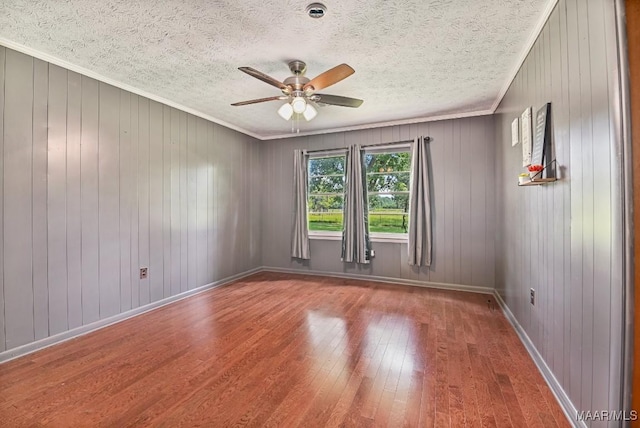 445 W Hickory Grove Rd, Lapine, AL 36046 - unfurnished room with a ceiling fan, wood-type flooring, crown molding, a textured ceiling, and wooden walls