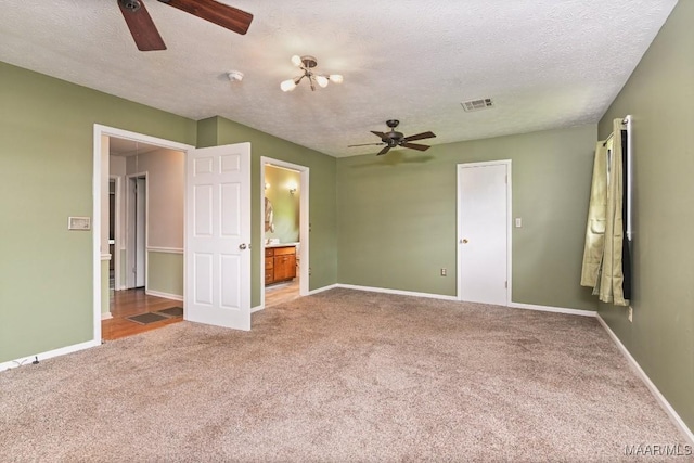 445 W Hickory Grove Rd, Lapine, AL 36046 - unfurnished bedroom with carpet flooring, a textured ceiling, ensuite bathroom, and ceiling fan