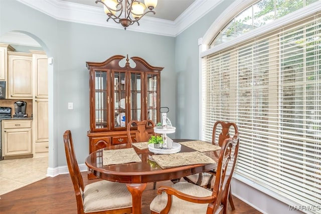 204 Village Way, Wetumpka, AL 36093 - dining space featuring a chandelier, arched walkways, ornamental molding, and light wood-style floors