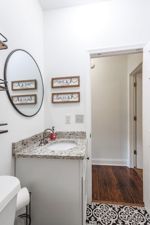 205 Jennifer Ln, Deatsville, AL 36022 - half bathroom with vanity and wood finished floors