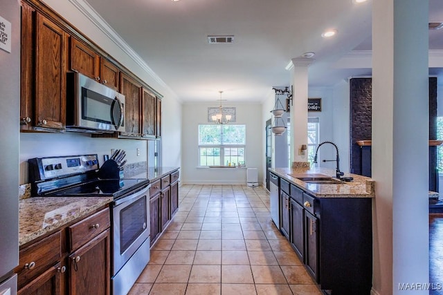 205 Jennifer Ln, Deatsville, AL 36022 - kitchen with appliances with stainless steel finishes, crown molding, light stone countertops, a chandelier, and light tile patterned flooring