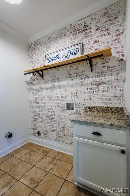 205 Jennifer Ln, Deatsville, AL 36022 - laundry room with washer hookup, ornamental molding, cabinet space, and light tile patterned flooring