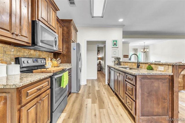447 Galloway Dr, Wetumpka, AL 36093 - kitchen featuring appliances with stainless steel finishes, light wood-style flooring, tasteful backsplash, a chandelier, and recessed lighting