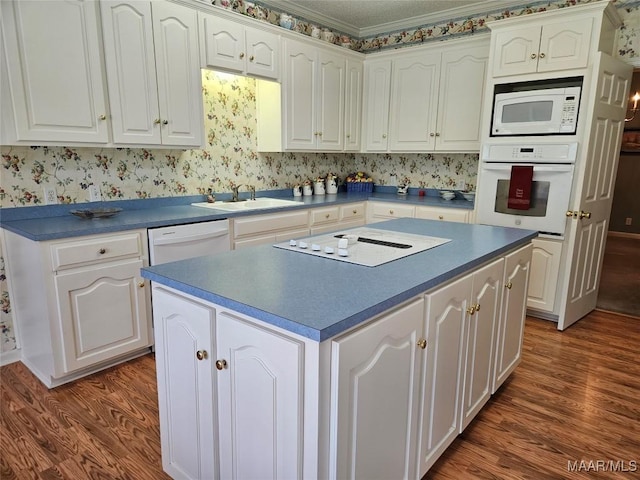 2714 Luverne Hwy, Greenville, AL 36037 - kitchen featuring white appliances, wood finished floors, and white cabinetry
