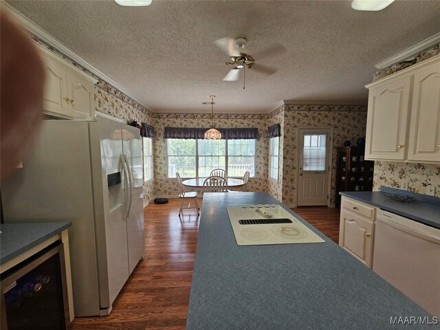 2714 Luverne Hwy, Greenville, AL 36037 - kitchen with wallpapered walls, white appliances, dark countertops, wine cooler, and dark wood-style flooring