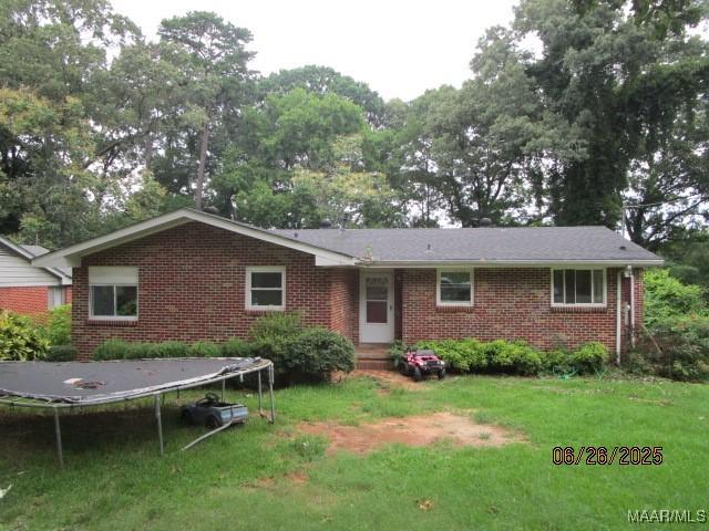 238 Easthaven Rd, Montgomery, AL 36109 - view of front facade with a trampoline, brick siding, and a front yard