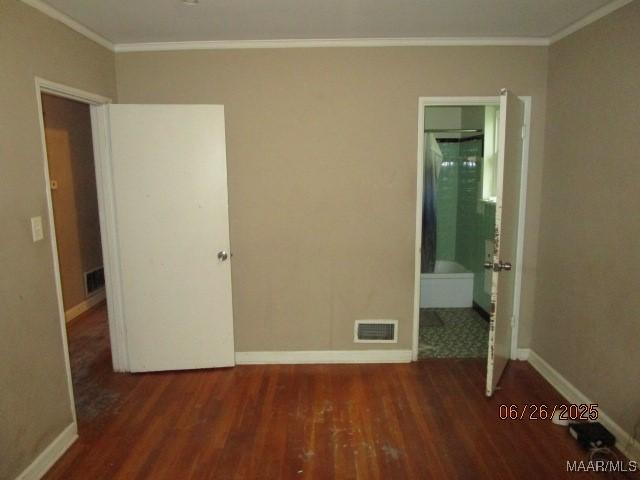 238 Easthaven Rd, Montgomery, AL 36109 - unfurnished bedroom with crown molding, wood finished floors, and ensuite bathroom