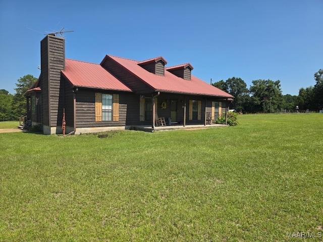 973 Pettus Rd, Lapine, AL 36046 - rear view of property with a chimney, a metal roof, and a lawn
