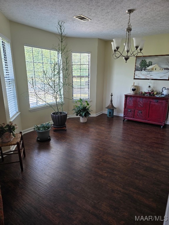 973 Pettus Rd, Lapine, AL 36046 - dining room featuring wood finished floors, a chandelier, and a textured ceiling