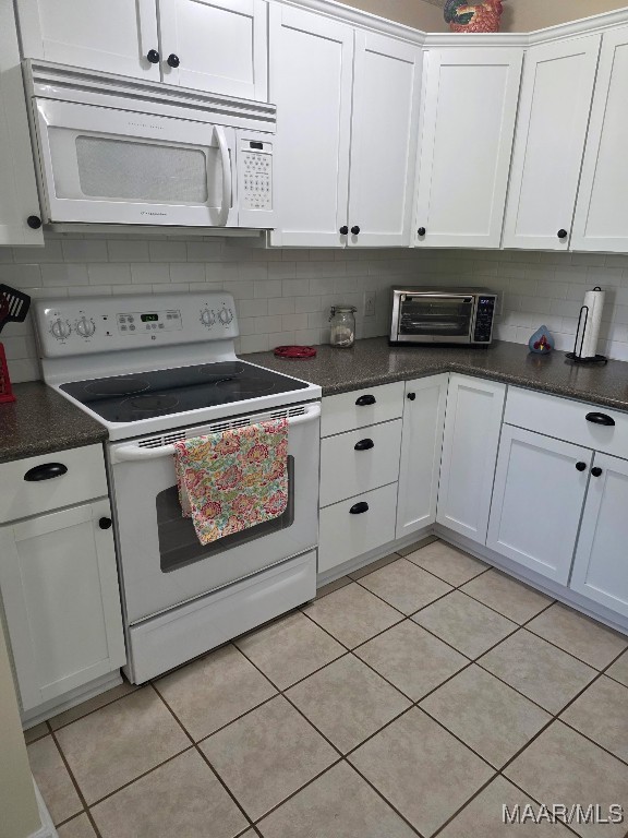 973 Pettus Rd, Lapine, AL 36046 - kitchen featuring white appliances, tasteful backsplash, white cabinetry, and light tile patterned floors
