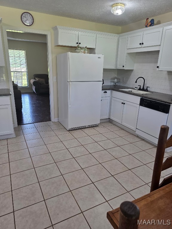 973 Pettus Rd, Lapine, AL 36046 - kitchen with white appliances, dark countertops, white cabinetry, and a textured ceiling