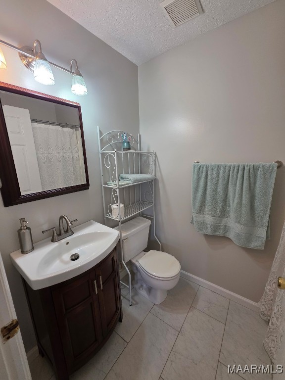 973 Pettus Rd, Lapine, AL 36046 - bathroom featuring vanity and a textured ceiling