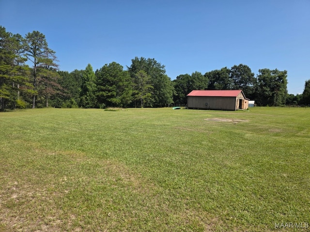 973 Pettus Rd, Lapine, AL 36046 - view of grassy yard with an outdoor structure and a view of trees