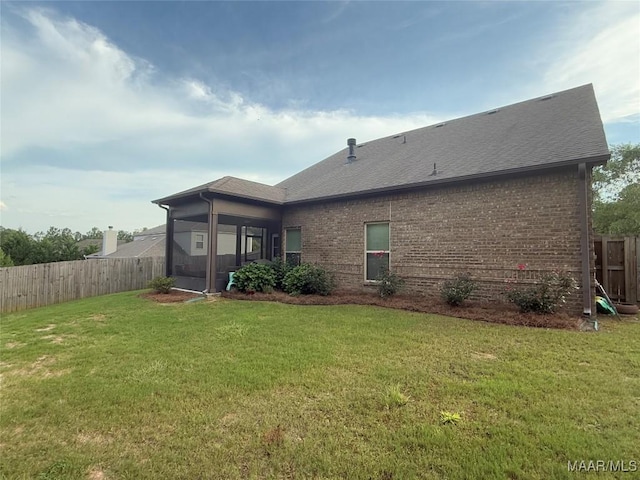 178 Natures Trl, Wetumpka, AL 36093 - rear view of property featuring a fenced backyard, a sunroom, brick siding, and a shingled roof