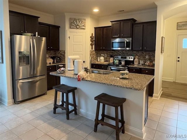 178 Natures Trl, Wetumpka, AL 36093 - kitchen featuring stainless steel appliances, light tile patterned floors, a breakfast bar area, backsplash, and recessed lighting