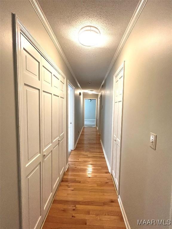 2 Rolling Hills Cir, Camden, AL 36726 - hallway featuring a textured ceiling, ornamental molding, and light wood finished floors