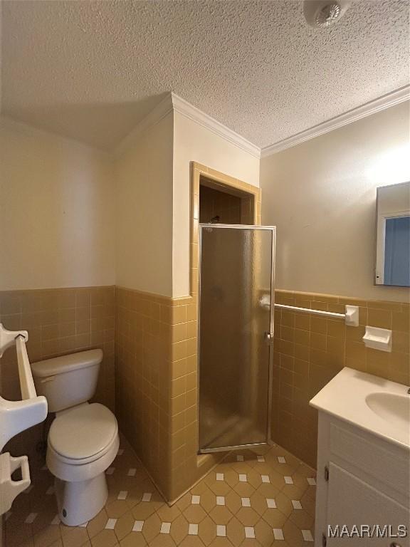 2 Rolling Hills Cir, Camden, AL 36726 - full bathroom featuring tile walls, tile patterned floors, crown molding, a shower stall, and vanity