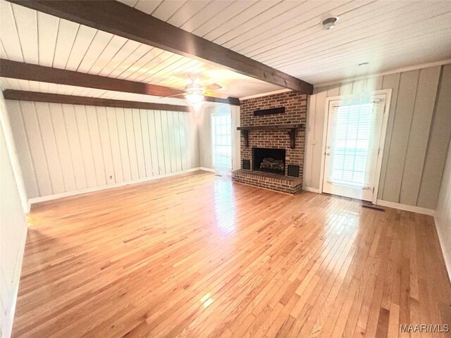 2 Rolling Hills Cir, Camden, AL 36726 - unfurnished living room with beam ceiling, ceiling fan, hardwood / wood-style floors, a brick fireplace, and plenty of natural light