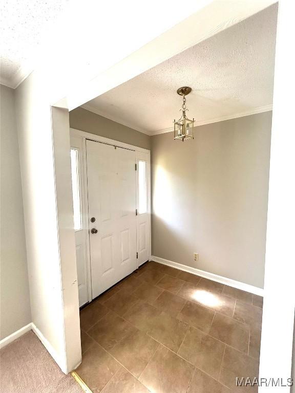 2 Rolling Hills Cir, Camden, AL 36726 - entrance foyer with a textured ceiling, ornamental molding, and a chandelier