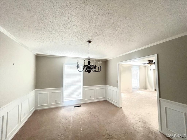 2 Rolling Hills Cir, Camden, AL 36726 - unfurnished dining area with crown molding, a decorative wall, healthy amount of natural light, a chandelier, and a wainscoted wall