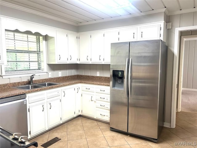 2 Rolling Hills Cir, Camden, AL 36726 - kitchen with appliances with stainless steel finishes, ornamental molding, dark countertops, light tile patterned floors, and white cabinetry